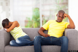 black couple disconnected on couch